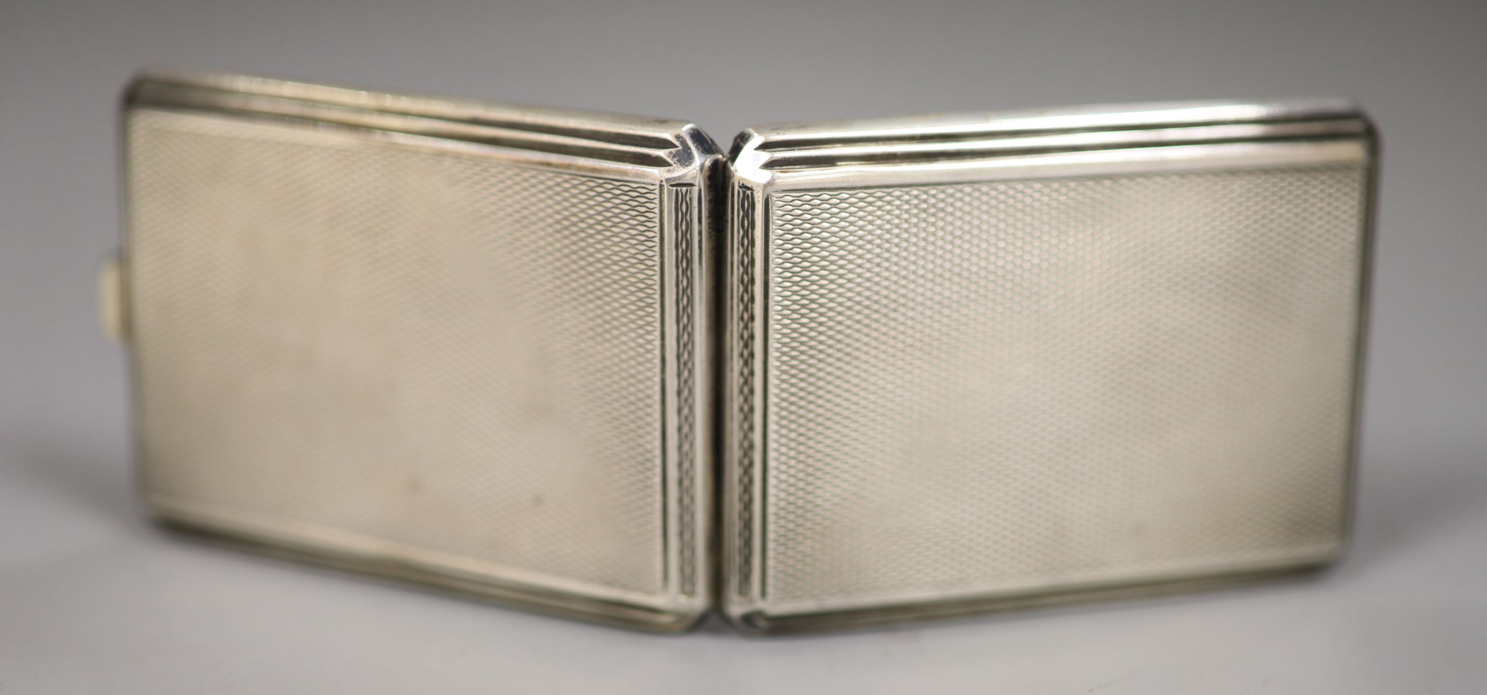 A Victorian engine turned silver card case, Birmingham, 1866 and a George V silver small card case, 63mm.